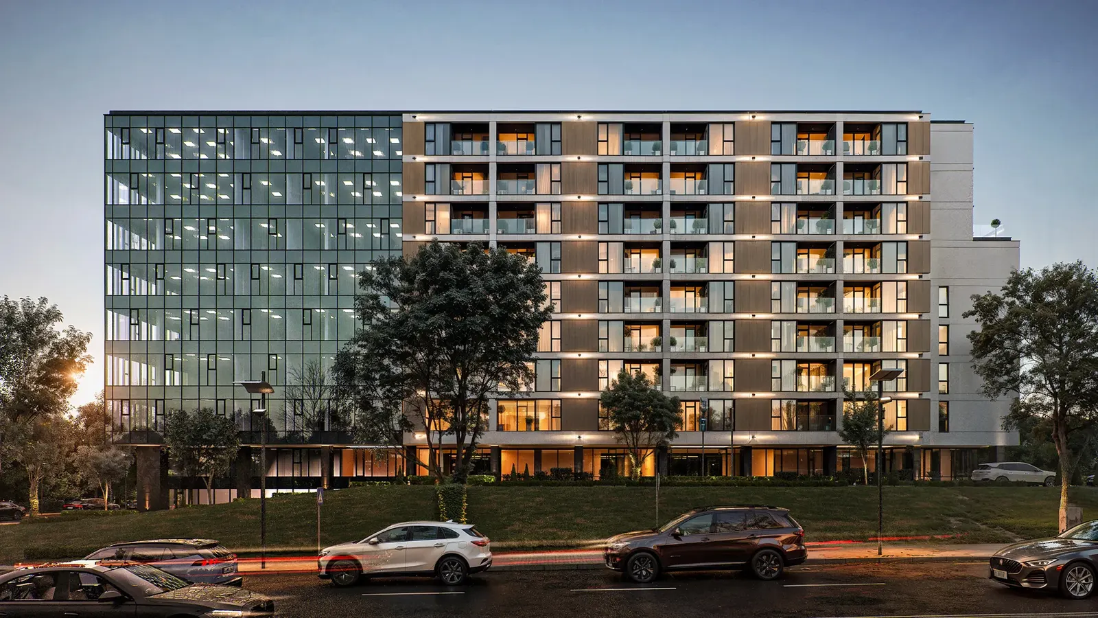 Office building with a glass facade at sunset