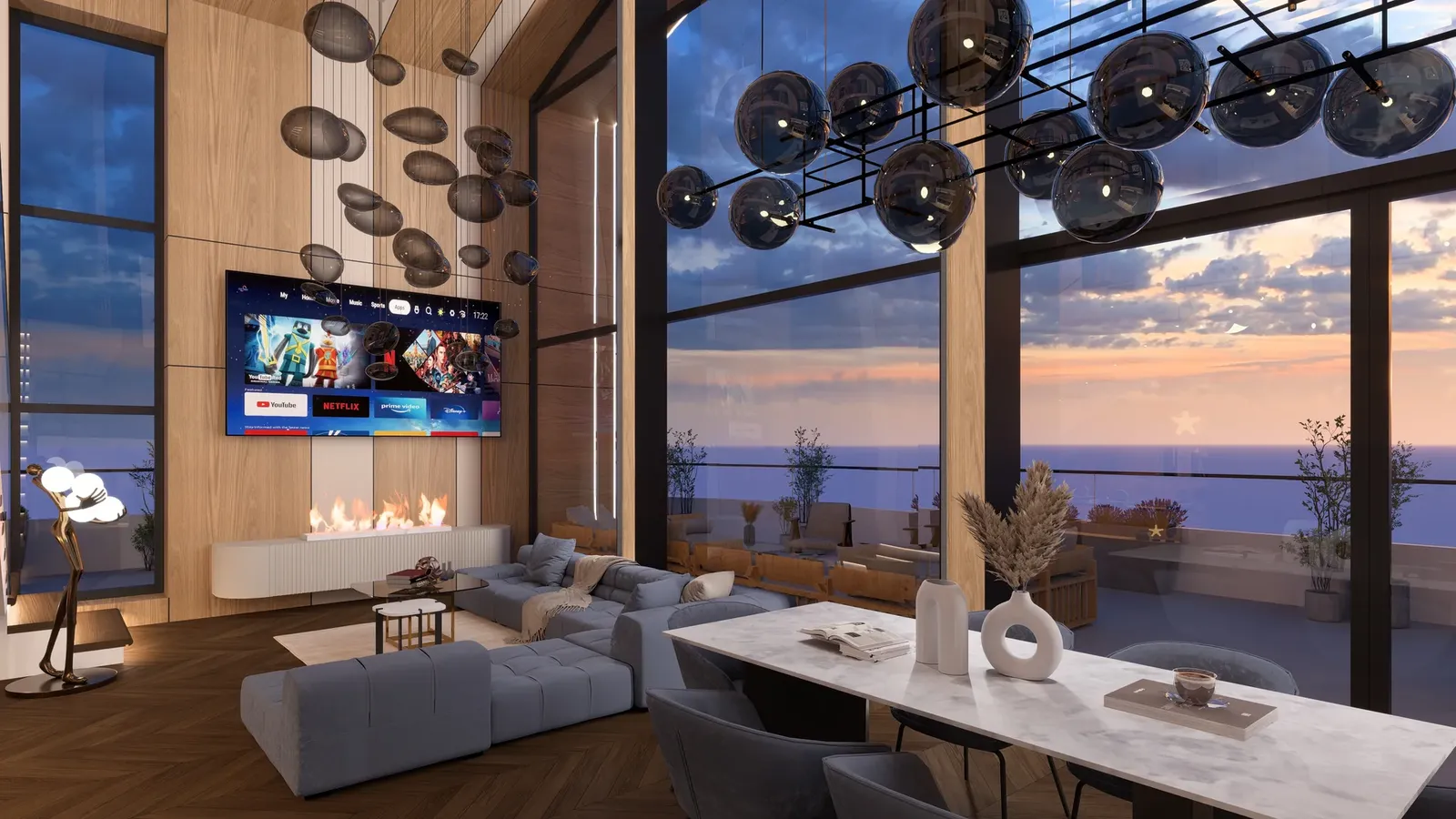 Living and dining area with panoramic glazing at sunset