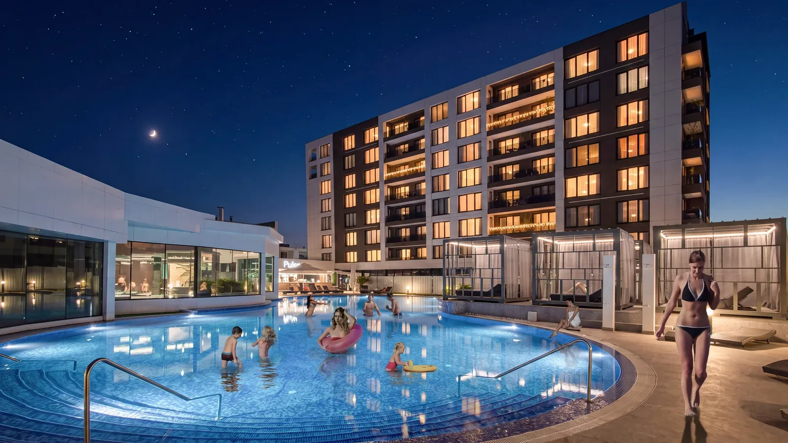 The pool and building at night